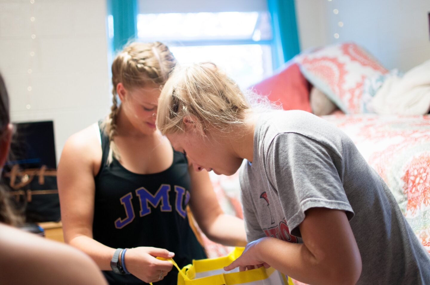 Two roommates in a college dorm organizing their bedroom and getting along